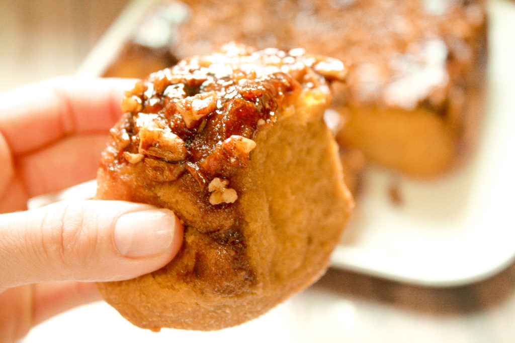 holding vegan pumpkin sticky buns